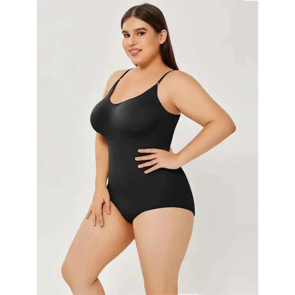 Black plus size women tummy control swimsuit with thin spaghetti straps and smooth form-fitting fabric