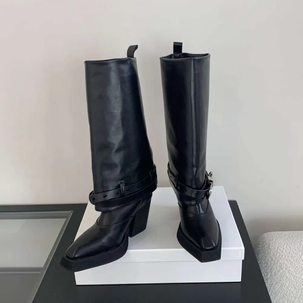 Black leather knight boots with pointed toe, chunky heel, knee-high length, and decorative buckle straps