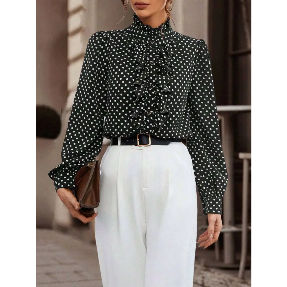 Black polka dot ruffled long sleeve shirt made of lightweight fabric featuring a ruffled front design