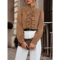 Brown polka dot blouse with ruffled front and puff sleeves made of lightweight fabric, complementing black polka dot style
