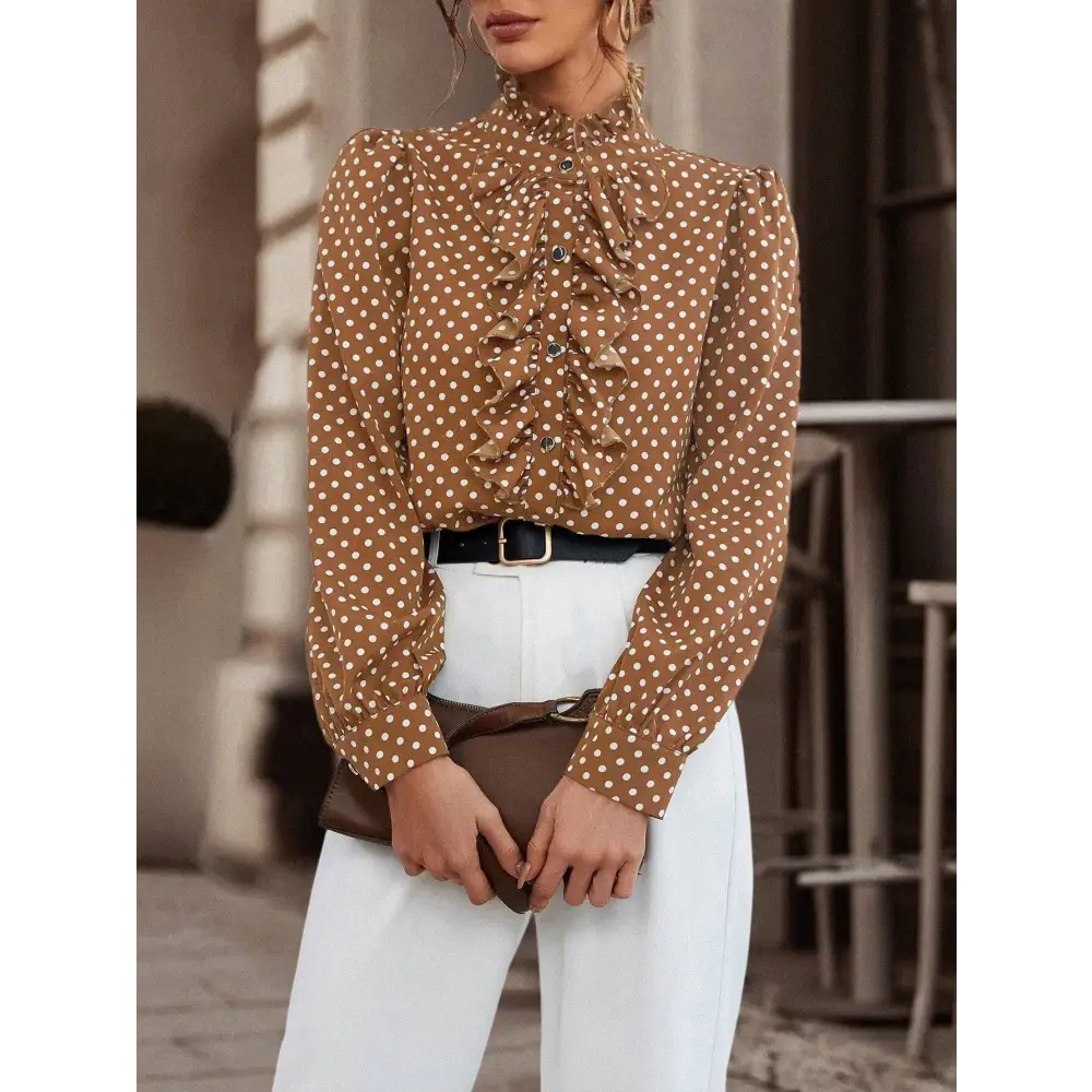 Brown polka dot blouse with ruffled front and puff sleeves made of lightweight fabric, complementing black polka dot style