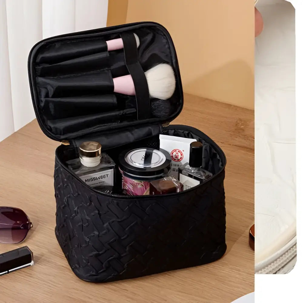 Black premium large capacity cosmetic bag with woven texture gold-tone zipper and interior compartments for makeup brushes
