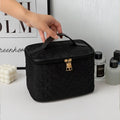 Black premium large capacity cosmetic bag with black woven texture and gold-tone zipper pull and handle
