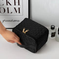 Black premium large capacity cosmetic bag with black woven texture gold-tone zipper and matching handle