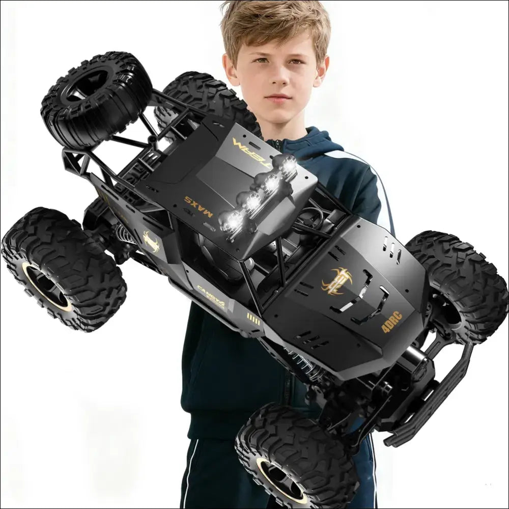 Black remote control rock crawler with rugged tires and gold accents featuring rechargeable batteries