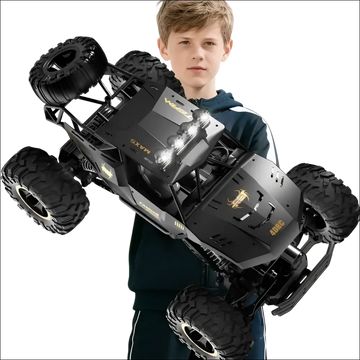 Black remote control rock crawler with rugged tires gold-accented branding and rechargeable batteries