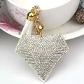 A sparkling diamond-shaped bag pendant with clear rhinestones and gold-toned chain features creative tassel design