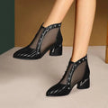 Black mesh heel sandals with a glossy finish, decorative silver studs, black rhinestone rose, and sleek block heel