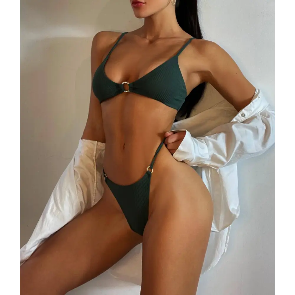 Dark green ribbed bikini set with gold toned metal accents featuring black ribbed circular design elements