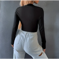 Black ribbed slim long sleeve crop top with half zip detail made from ribbed fabric for a sleek fit