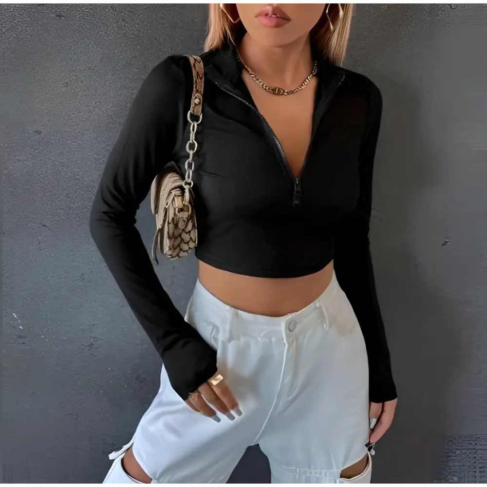 Black ribbed slim long sleeve crop top with half zip front detail and ribbed texture for a sleek fit