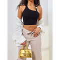 Gold metallic handbag with structured rectangular shape and prominent clasp detail complementing black ribbed solid shoulder vest featuring low cut one shoulder design