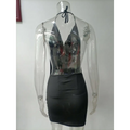 A sleek black ruched sling backless halter dress with a reflective silver halter top and black tie-back straps
