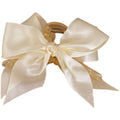 Cream satin female graceful bow grip with translucent gold-toned claw mechanism for elegant hair styling
