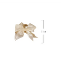 Cream satin female graceful bow grip with gold-toned metal base bow grip shark clip for elegant hairstyles