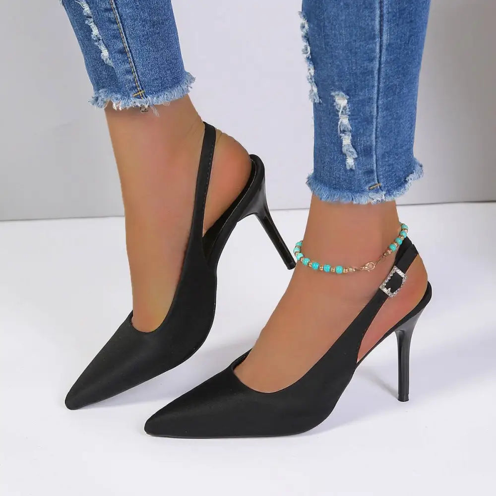 Black satin high heel sandals with pointed toe and slender heel in elegant slingback design