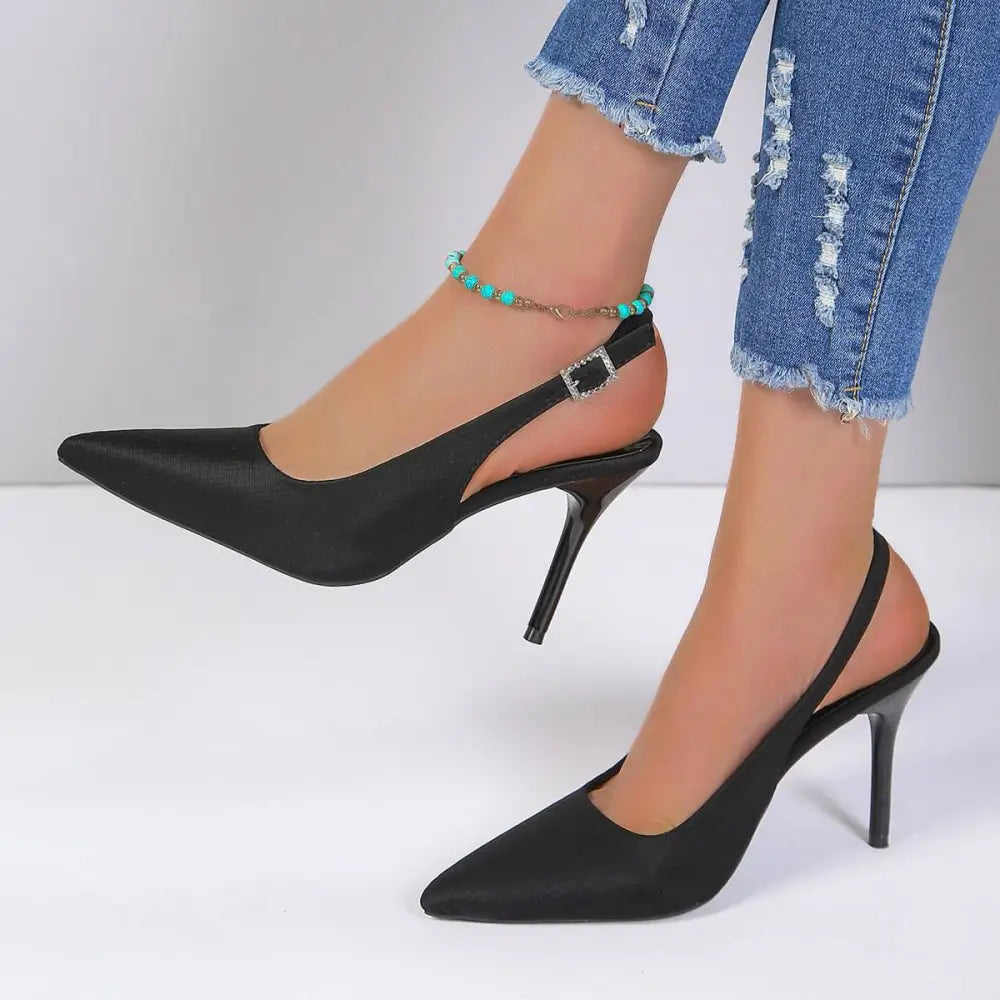 Black satin high heel sandals with a sleek pointed toe and thin suede high heel slingback design