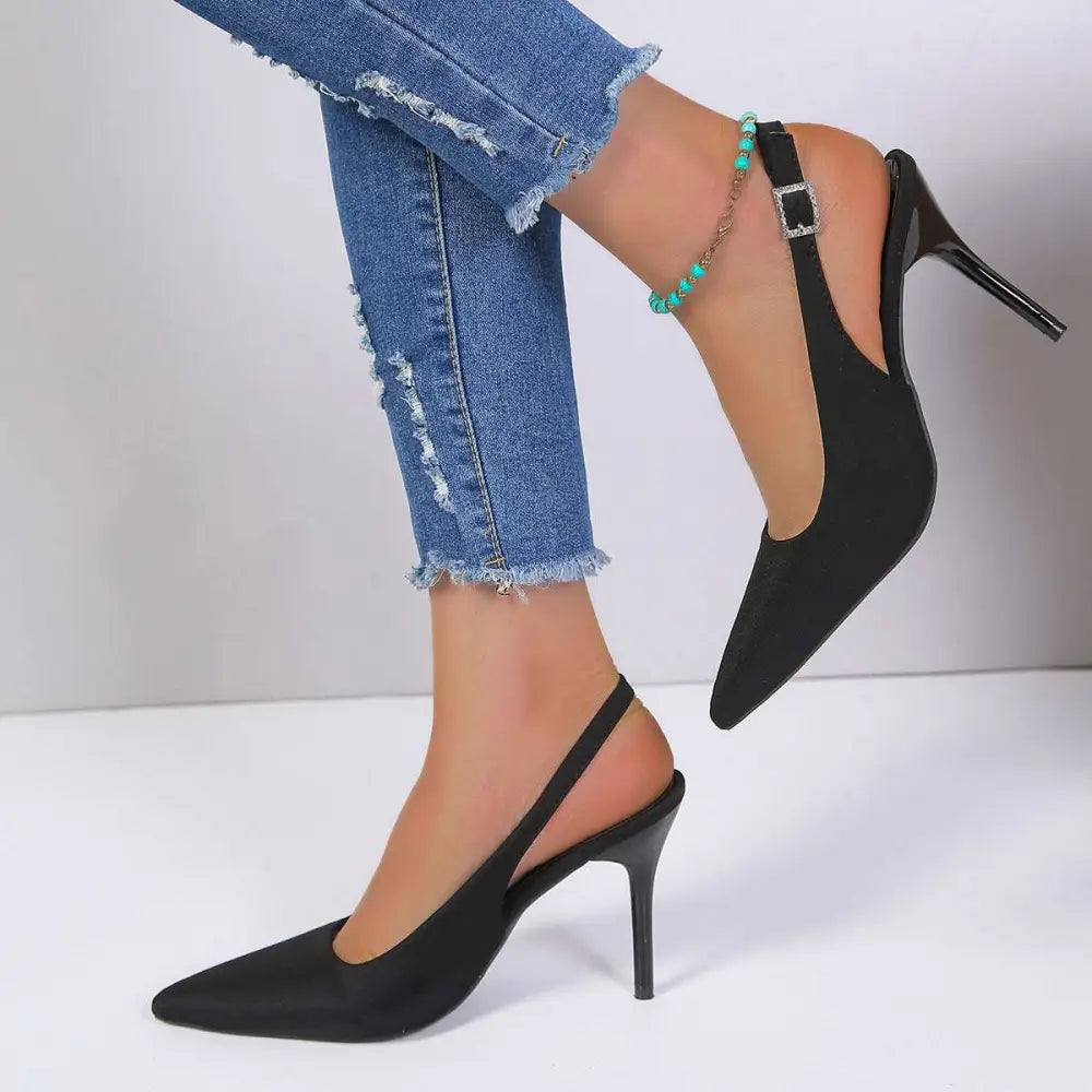 Black satin high heel sandals with a sleek pointed toe and thin suede high heel slingback design