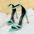 A pair of mint green satin high heel toe cutout sandals with a sleek open-toe design and ankle straps