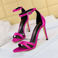 Vibrant fuchsia satin high heel toe cutout sandals with sleek ankle strap and metallic buckle