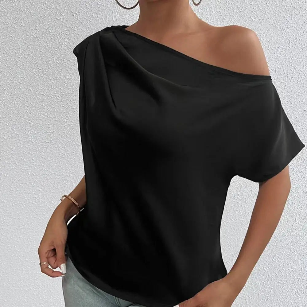 Black one-shoulder top with flowing satin fabric and short sleeves featuring a solid color asymmetrical collar design