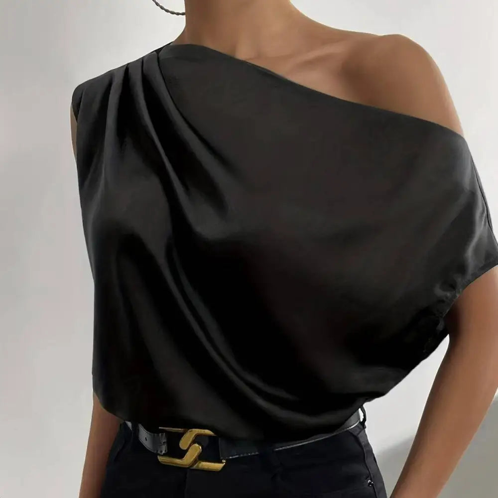 Black satin solid color asymmetrical one-shoulder blouse with a draped flowing design and color asymmetrical collar