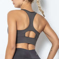 Dark gray seamless women’s shockproof running sports bra with racerback design and cutout details