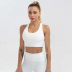 White seamless women’s shockproof running sports bra with racerback straps and breathable fabric for high impact workouts