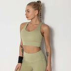 Olive green seamless women’s shockproof running sports bra with racerback design paired with high-waisted leggings