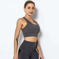 A sleek dark gray seamless women’s shockproof running sports bra with racerback design for high-impact support