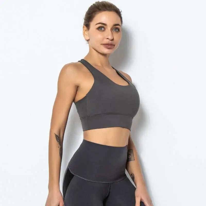 A sleek dark gray seamless women’s shockproof running sports bra with racerback design for high-impact support
