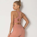 A sleek blush-pink seamless women’s shockproof running sports bra with high neckline and cutout back design