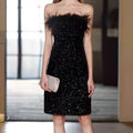 Black sequined feather trim banquet evening dress featuring a strapless design and feather trim neckline