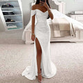 Silver off-the-shoulder mermaid gown with ruched bodice high slit and flowing train in black sequined fabric