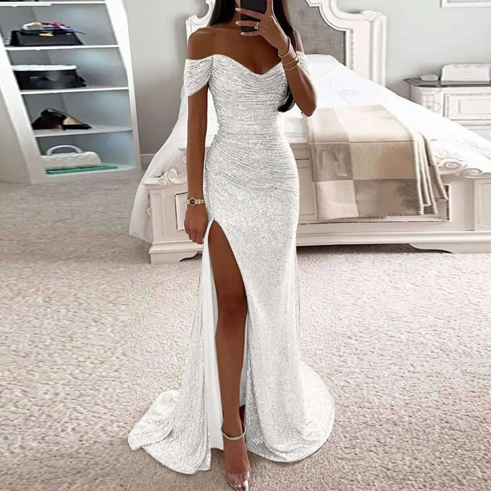 Silver off-the-shoulder mermaid gown with ruched bodice high slit and flowing train in black sequined fabric