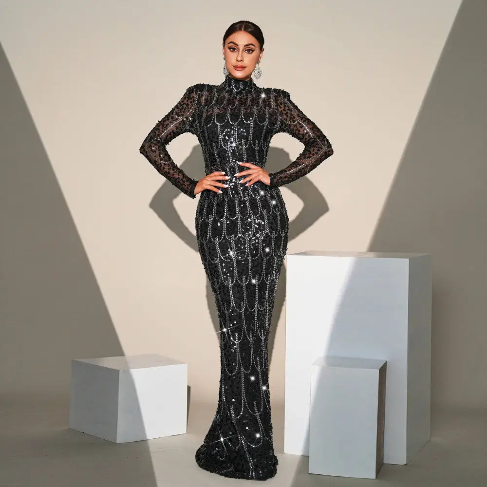 Black sequined long sleeve round neck evening dress with sheer sleeves and silver chain details for banquet evening events