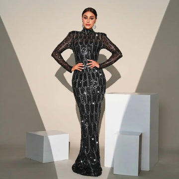 Black sequined long sleeve round neck evening dress with sheer sleeves and silver chain details for banquet evening events