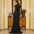 A shimmering black sequined long sleeve round neck fishtail gown with sheer sleeves and elegant design