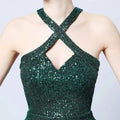 Emerald green sequined halter neckline mermaid dress with crisscross back design shown from the back side