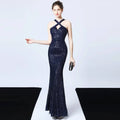 A shimmering navy blue sequined mermaid dress with halter neckline and crisscross straps for elegant events