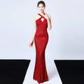 A shimmering red sequined mermaid dress with a halter neckline and fitted silhouette in long skirt length