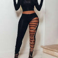 Black high-waisted ripped leggings with sheer side slits and gold chain accents for casual sexy ripped style