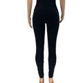 Black stretchy form-fitting leggings featuring ripped detailing and a sheer gold chain for casual sexy ripped style