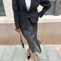 Black sheer high waist slit sheath skirt paired with solid black blazer and matching high heels in a formal look