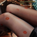 Translucent black sheer snagging resistant sock leggings with playful orange lipstick print and lettering design