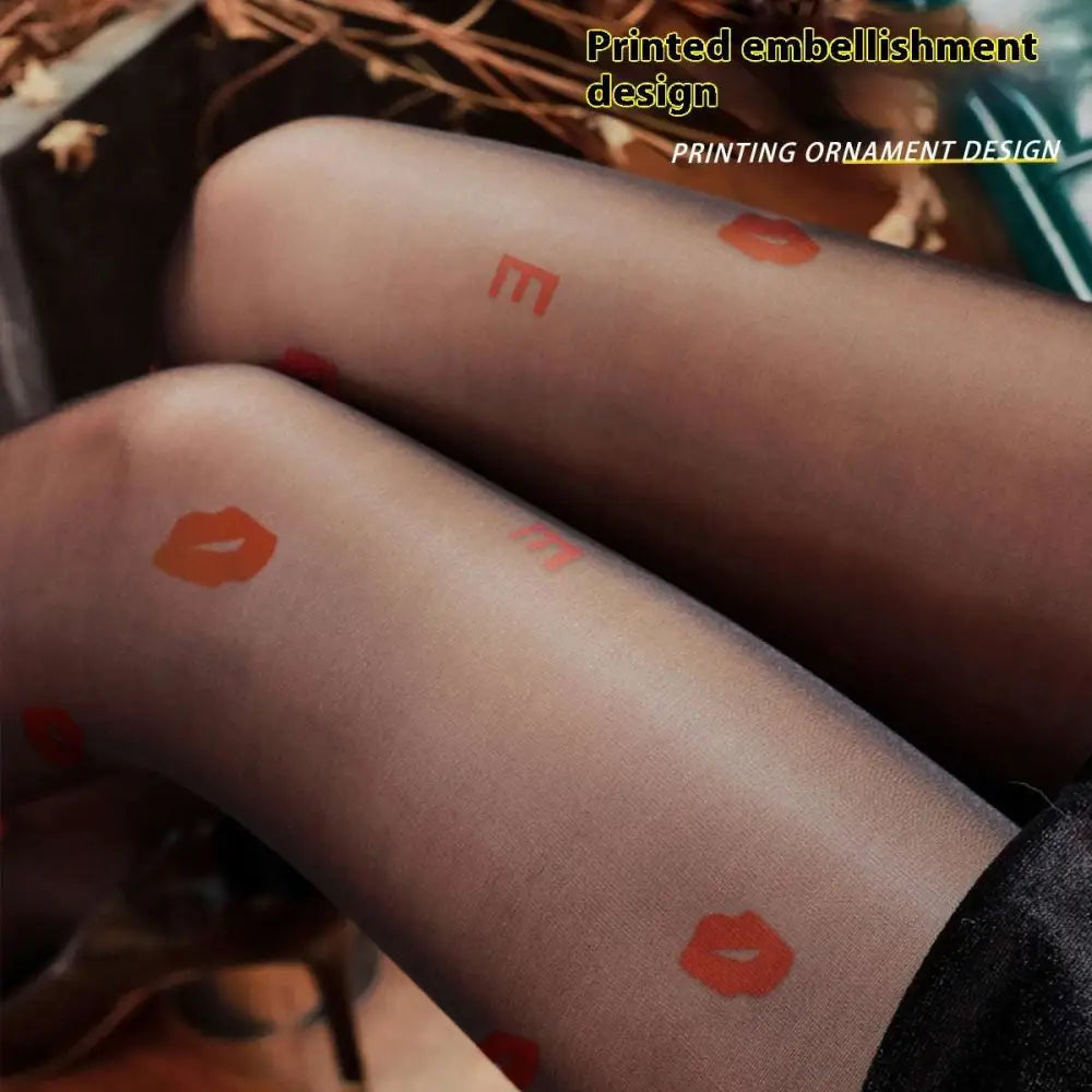 Translucent black sheer snagging resistant sock leggings with playful orange lipstick print and lettering design