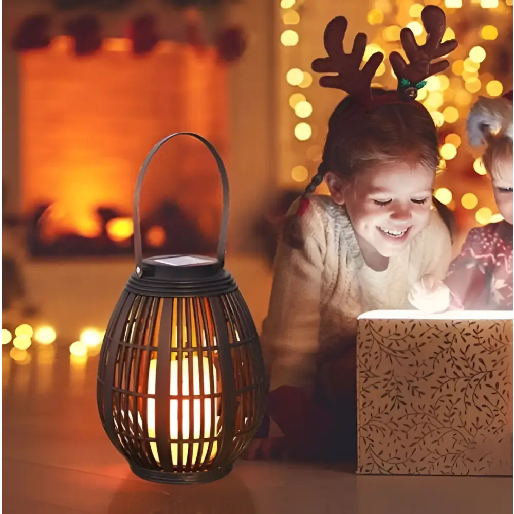 Black solar retro patio woven rattan lantern with warm glowing light and solar panel on top