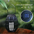 Black solar retro patio woven rattan lantern with handle and vertical slats featuring ipx4 waterproof rating