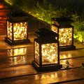 Black solar waterproof garden hanging lights featuring black lanterns with warm glowing fairy lights inside