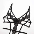Black solid color lace bodysuit with intricate floral patterns and thin satin straps in a lace bodysuit design